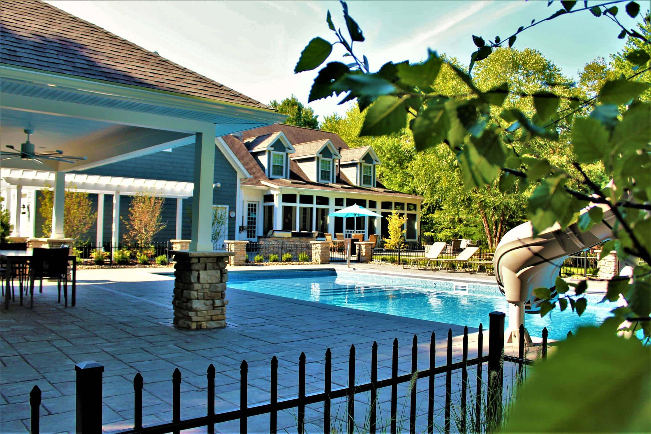 Night time view of pool and home lit up