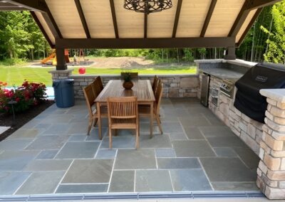 Fresh air gathering place features a complete outdoor kitchen.