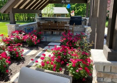 Stonework for raised flower beds adds color and beauty to the setting.