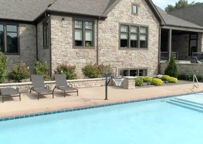 A permanently affixed poolside basketball hoop encourages group play in the water.