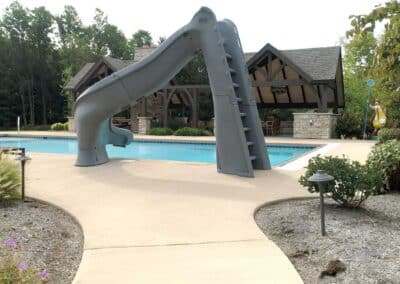 To level up the resort feel of the space, Brothers Grimm installed a slide that allows both kids and adults to make a splashy entrance into the pool.