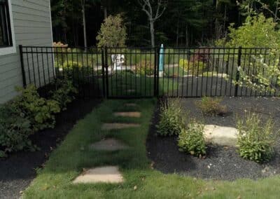 Stepping stones embedded in grass create a lush and inviting path to other areas of the property.
