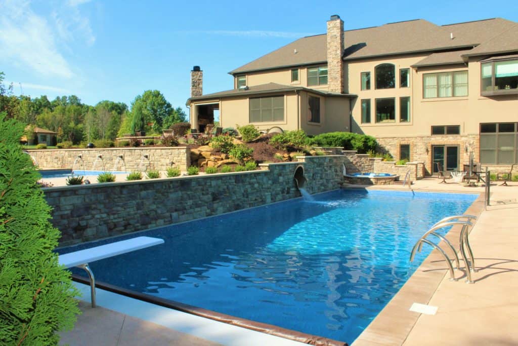 Home-resort-3 This two-pool combo with hot tub, slide and fire pit is one of our favorite projects.