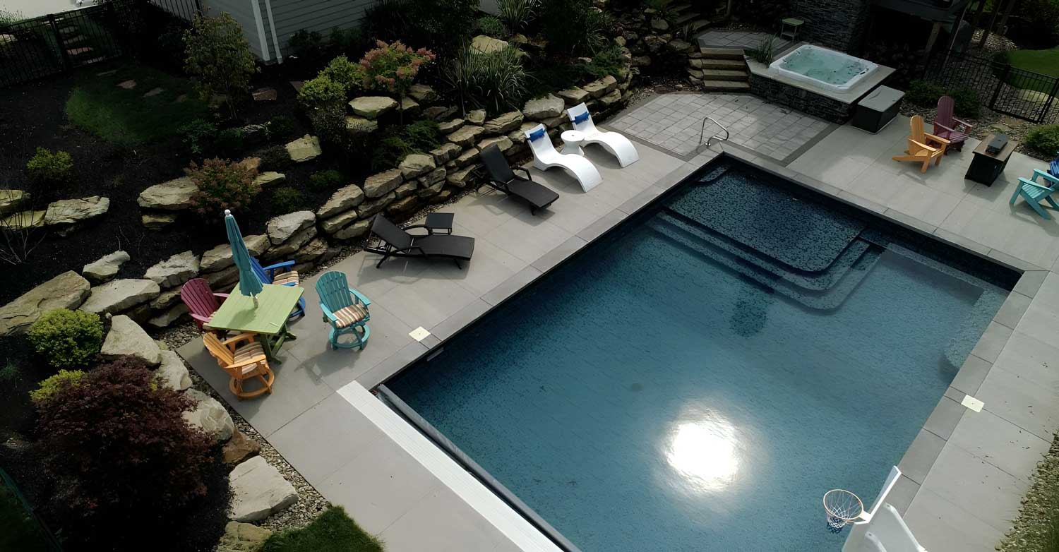 horgan-pool-seating overhead shot of a pool with a stone staircase leading into clear blue water