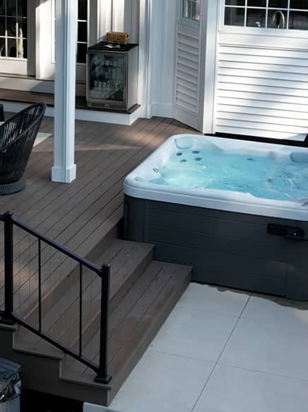 hottub overhead shot of a pool with a stone staircase leading into clear blue water