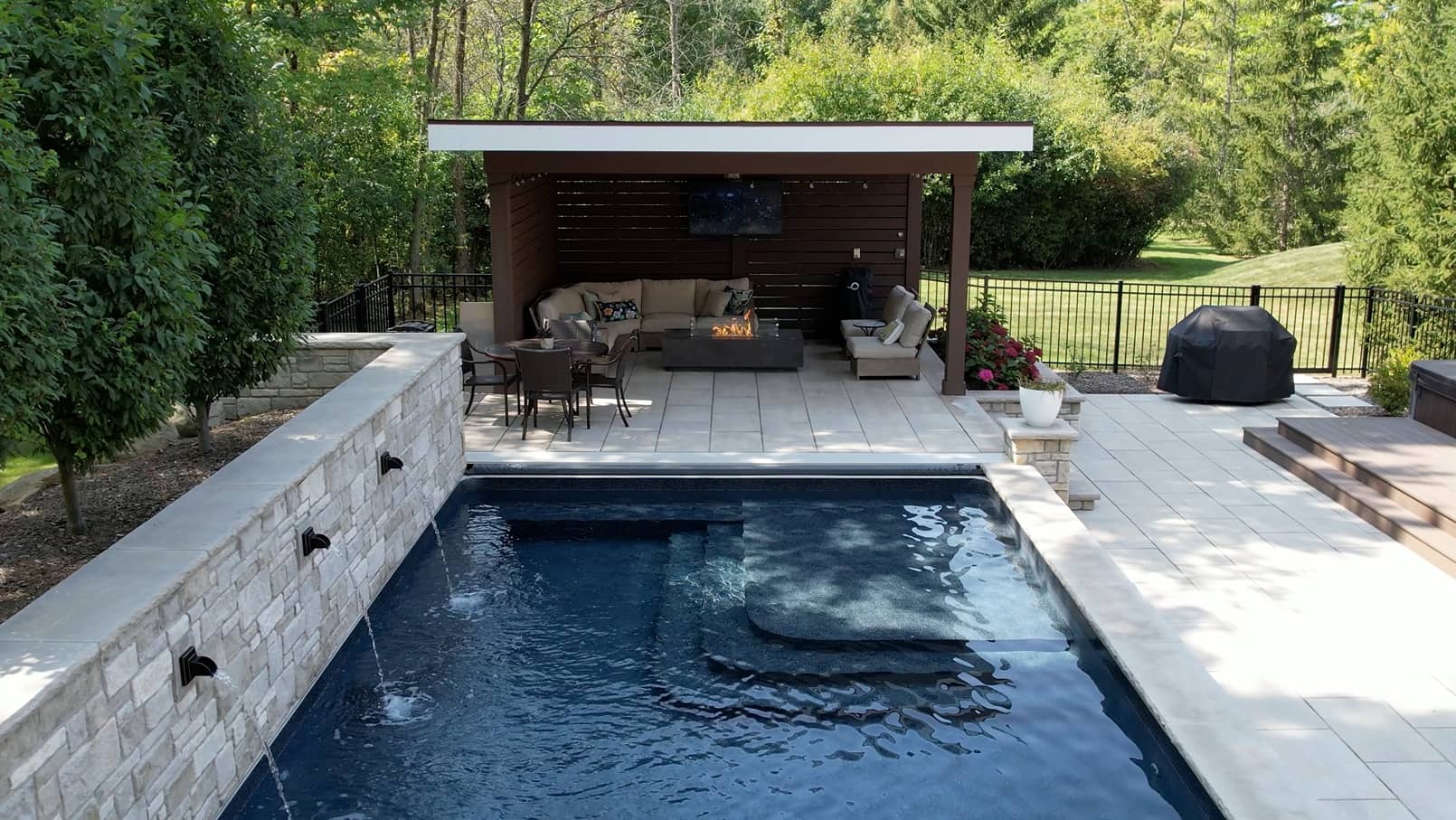 landscaping-3 overhead shot of a pool with a stone staircase leading into clear blue water