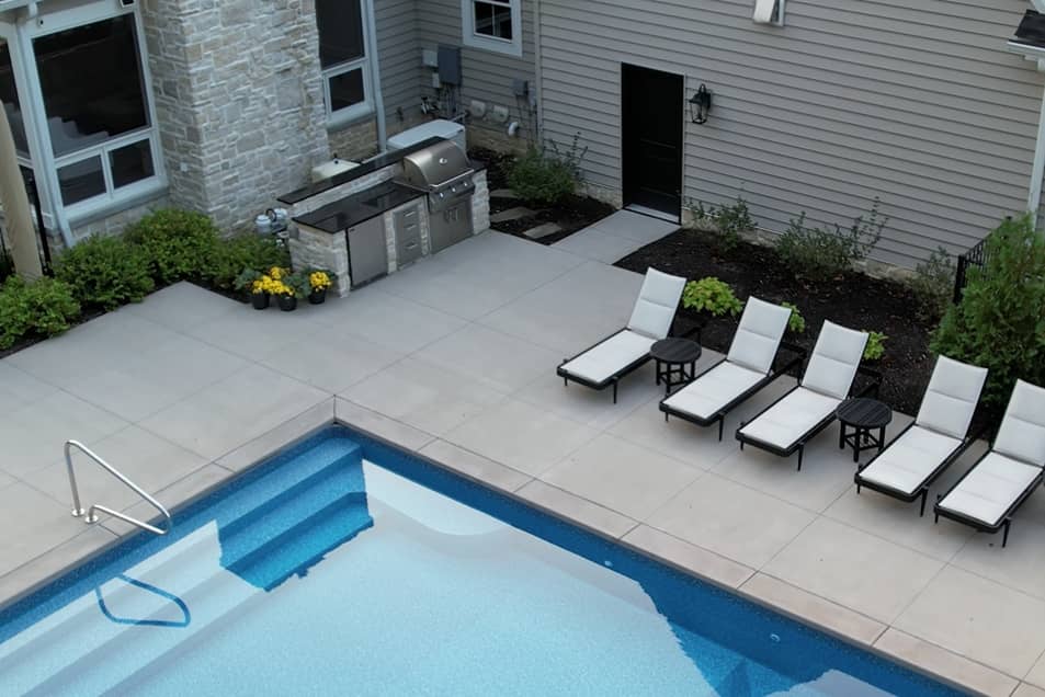 poolside-cropped the edge of a blue rectangle pool next to a built in kitchen on the patio