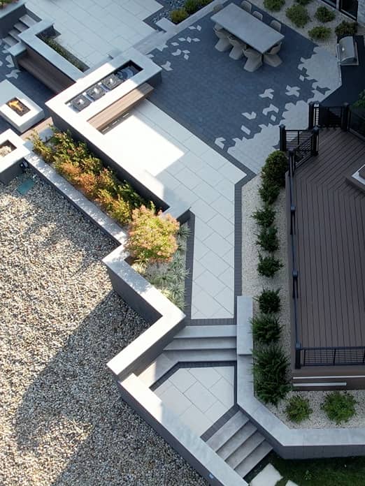 sprawling-deck aerial view highlighting the different colors and patterns that combine to create a luxury backyard resort